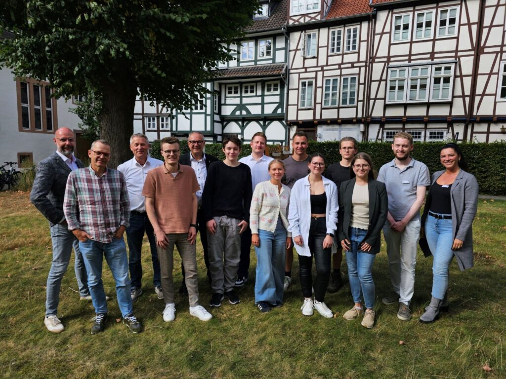 Frank Limpke (1. Beigeordneter und Kämmerer), Dieter Sonnenburg (Leiter der Personalabteilung) und Bürgermeister Markus Baier (hinten, von links) sowie weitere Mitarbeitende der Stadtverwaltung freuen sich, dass die ehemaligen Azubis als neue Kolleginnen und Kollegen im Team der Alten Hansestadt Lemgo bleiben.